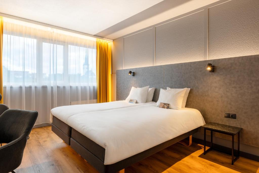 Postel nebo postele na pokoji v ubytování Metropol Hotel