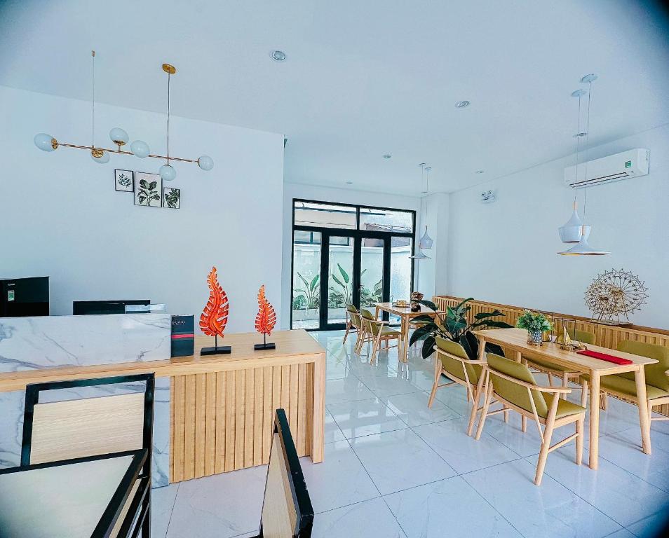 a dining room with tables and chairs in a room at Z Homestay 2 Phú Quốc in Phú Quốc