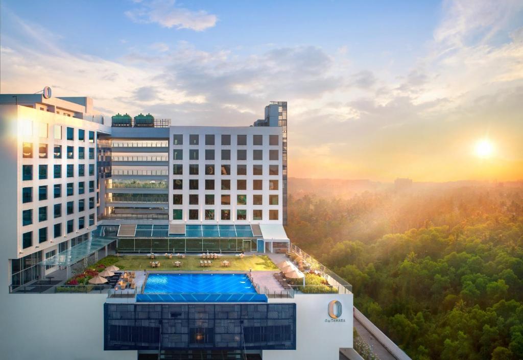 an aerial view of a building with a pool at O by Tamara, Trivandrum in Trivandrum