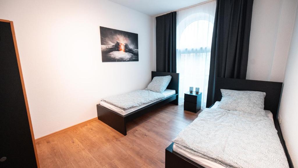 a room with two beds and a window at Monteurwohnung in Freren Lingen in Freren