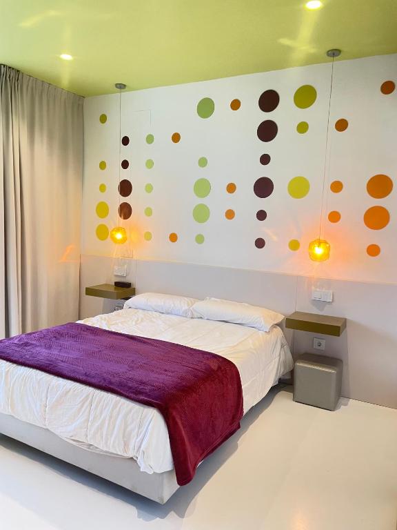 a bedroom with a bed and a painting on the wall at LAHOLA Glam Suites in Torremolinos