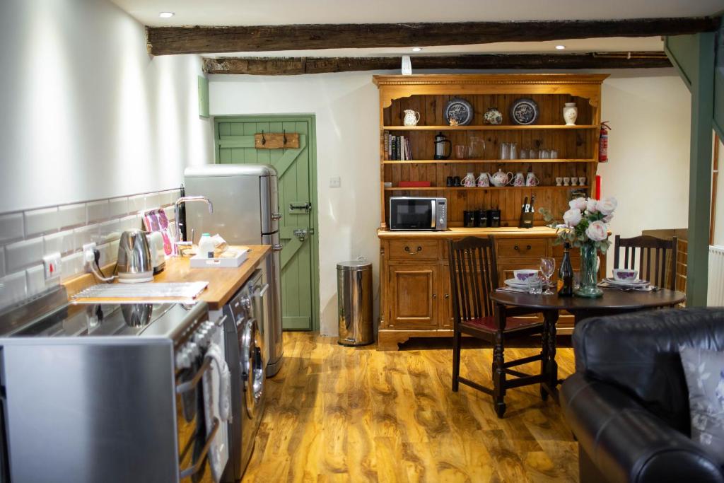a kitchen with a stove and a table in a room at Lavington Johnston in Johnston