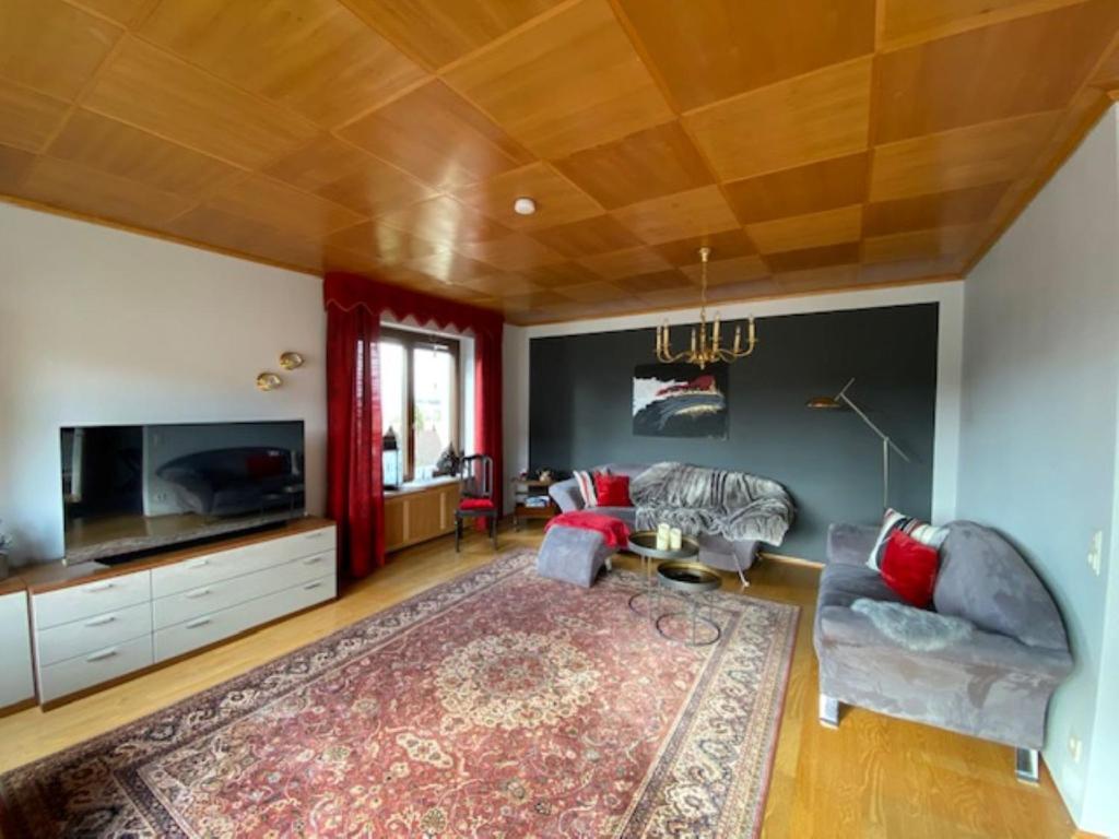 a living room with a couch and a tv at Ferienwohnung Fichtelnest in Zell im Fichtelgebirge