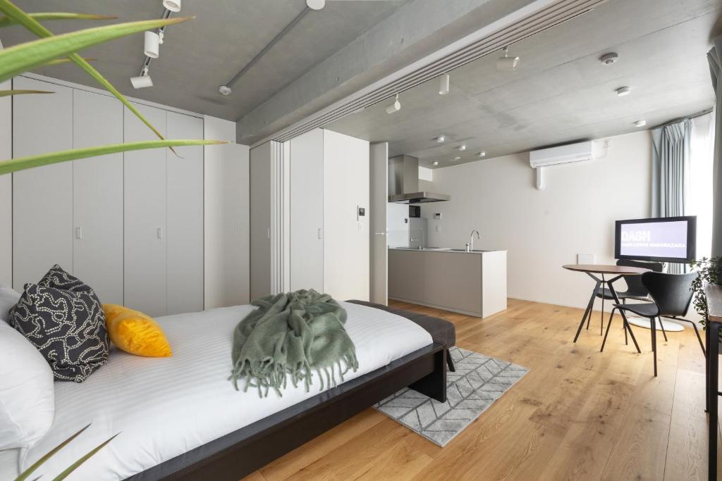 a bedroom with a bed and a desk in a room at Dash Living Kagurazaka in Tokyo