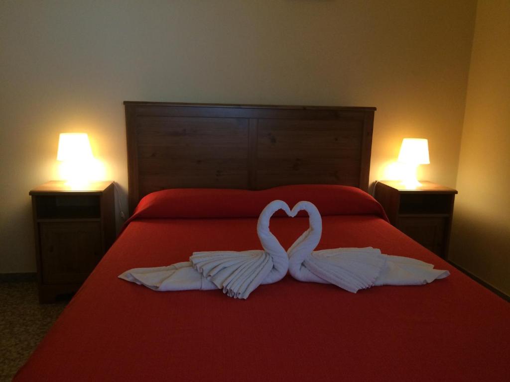 Postel nebo postele na pokoji v ubytování Apartamentos Domínguez