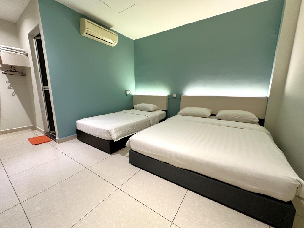 Postel nebo postele na pokoji v ubytování De UPTOWN Hotel @ P.J. 222