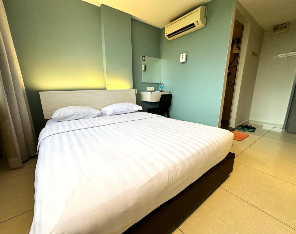 Postel nebo postele na pokoji v ubytování De UPTOWN Hotel @ P.J. 222