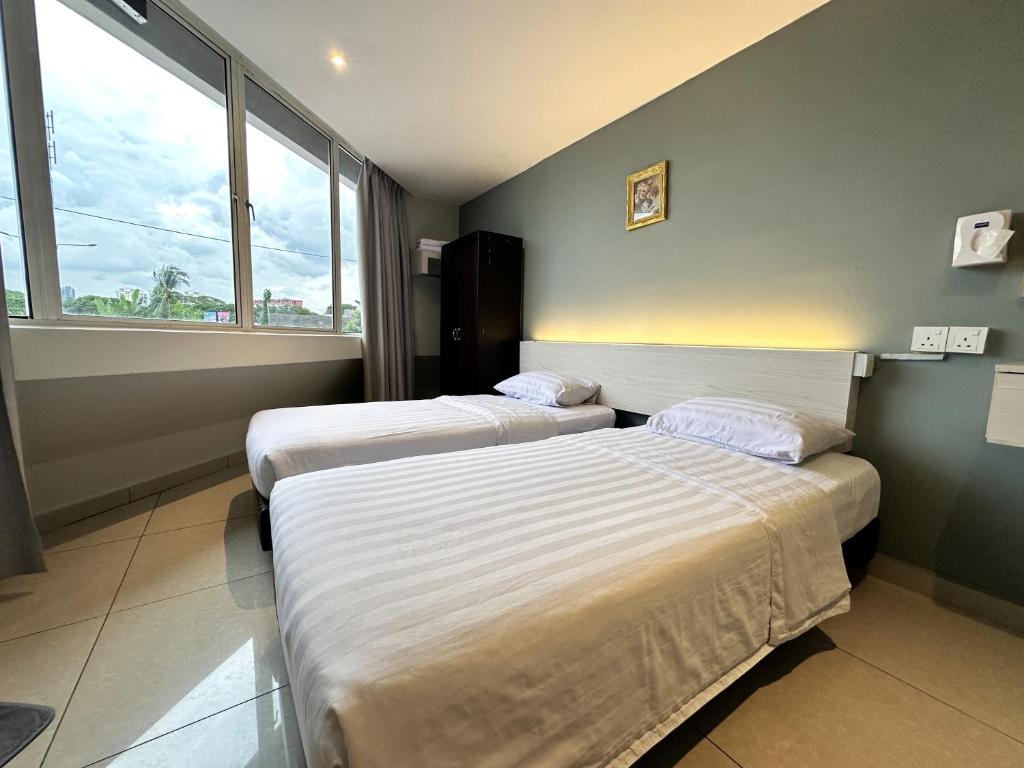 Postel nebo postele na pokoji v ubytování De UPTOWN Hotel @ P.J. 222