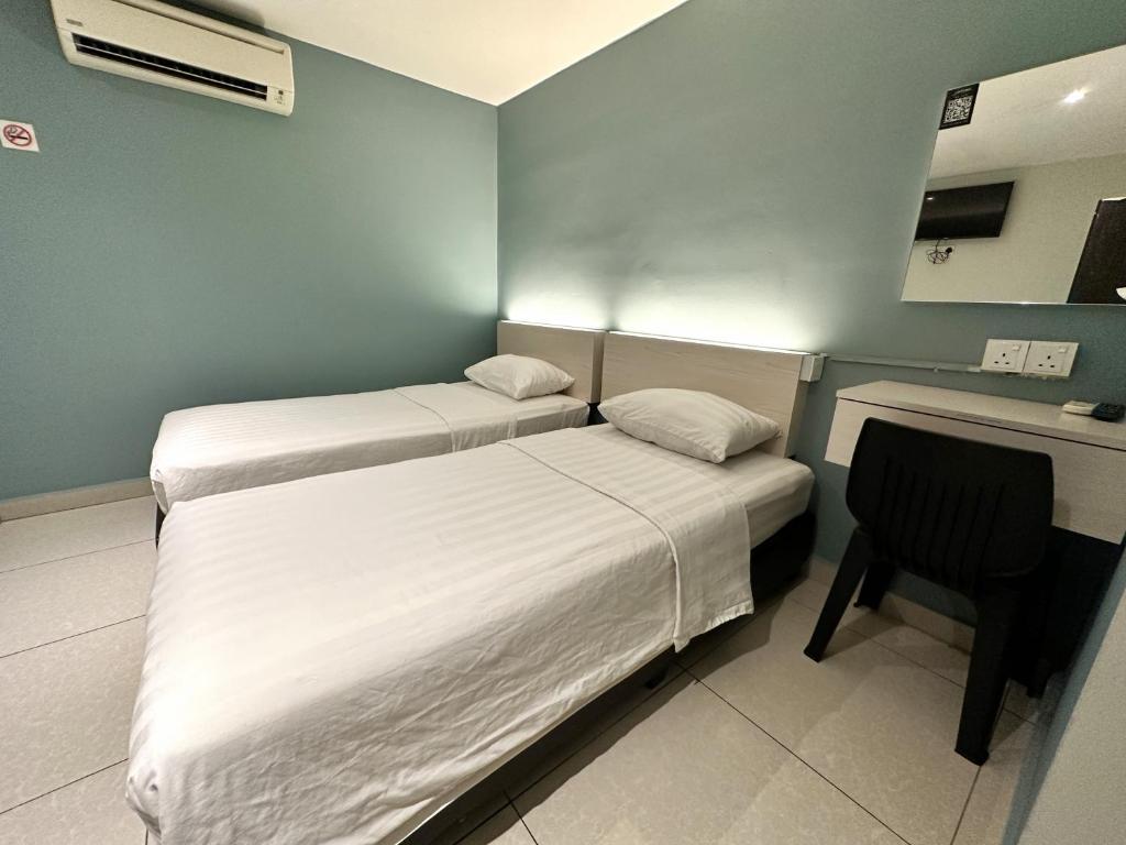 Postel nebo postele na pokoji v ubytování De UPTOWN Hotel @ P.J. 222