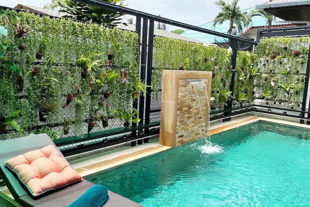 a swimming pool in a backyard with a garden at Peacefully Rawai 3 Bedrooms Pool Villa in Rawai Beach