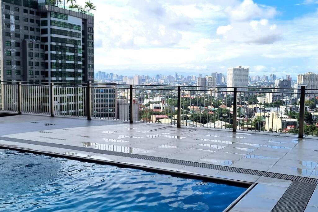 a swimming pool on the roof of a building at Apartment-Serviced & Condo Free pool in Quezon City by Mi'Casa in Manila