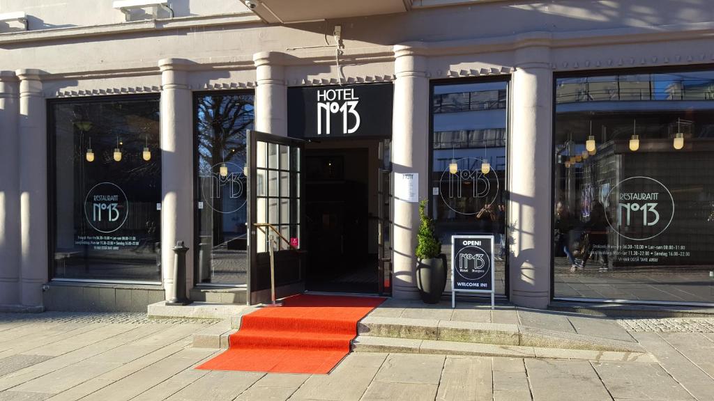 a store front with a red rug in front at Hotel No13 in Bergen