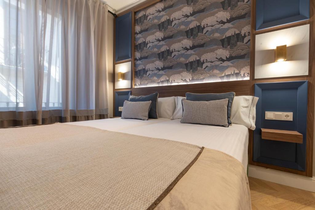Postel nebo postele na pokoji v ubytování BiBo Suites Palacio de Portago