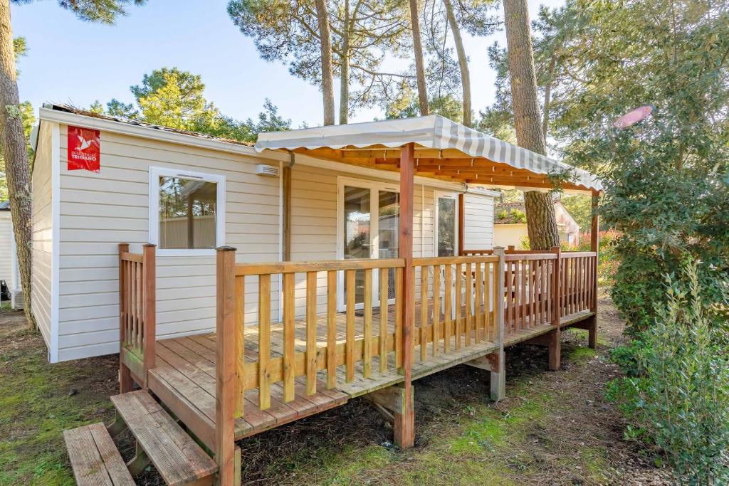 a house with a deck with a gazebo at Mobil home La Palmyre in Les Mathes