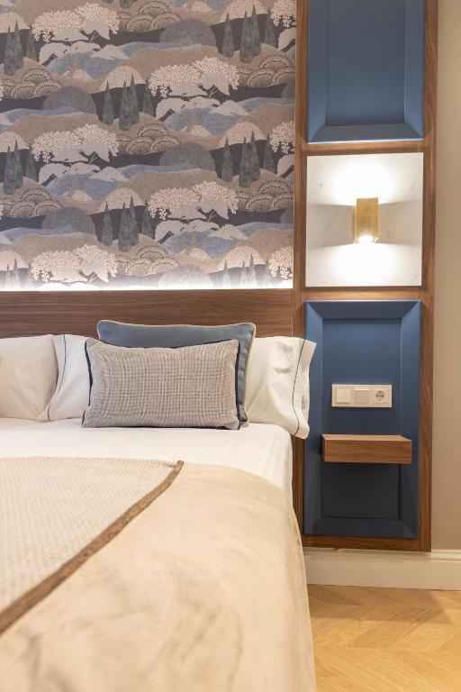 Postel nebo postele na pokoji v ubytování BiBo Suites Palacio de Portago