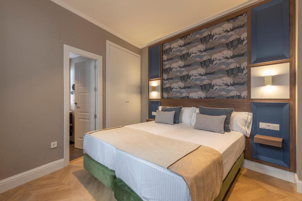 Postel nebo postele na pokoji v ubytování BiBo Suites Palacio de Portago