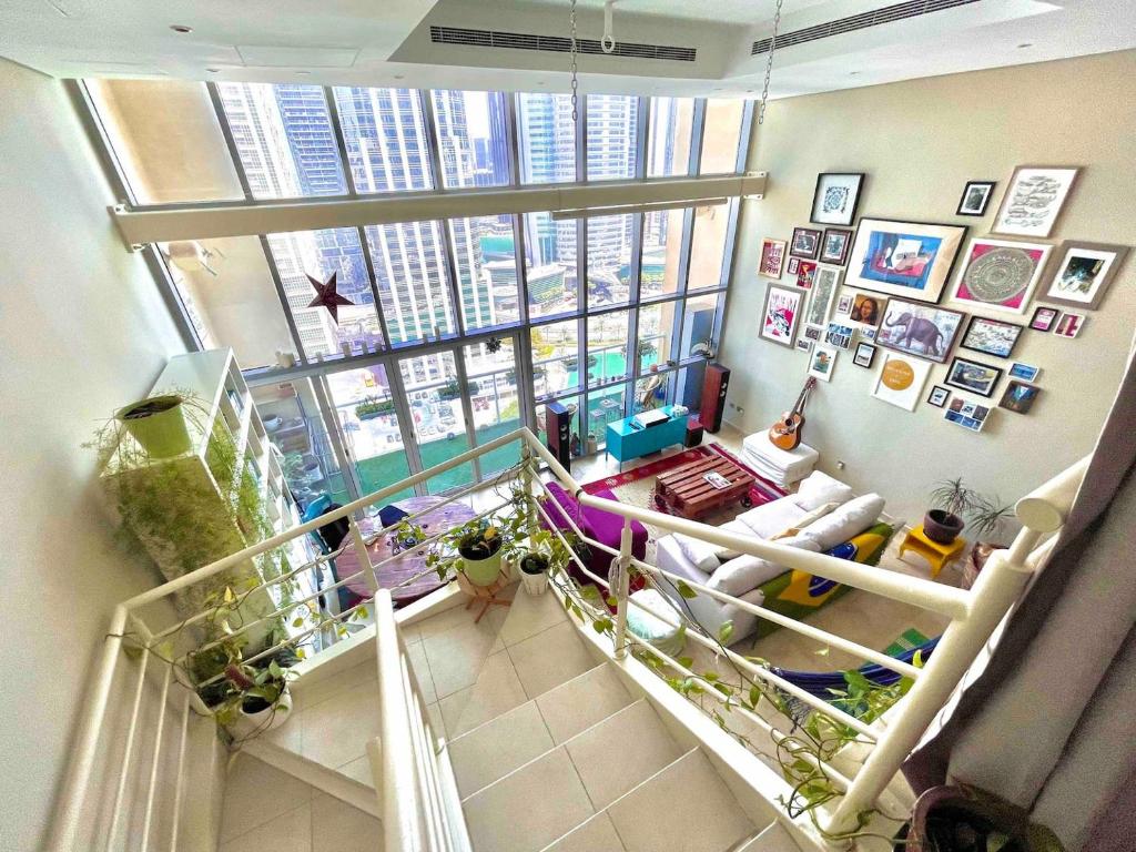 a view of a living room with a large window at Urban Oasis Duplex Loft Wabundant Natural Light in Dubai
