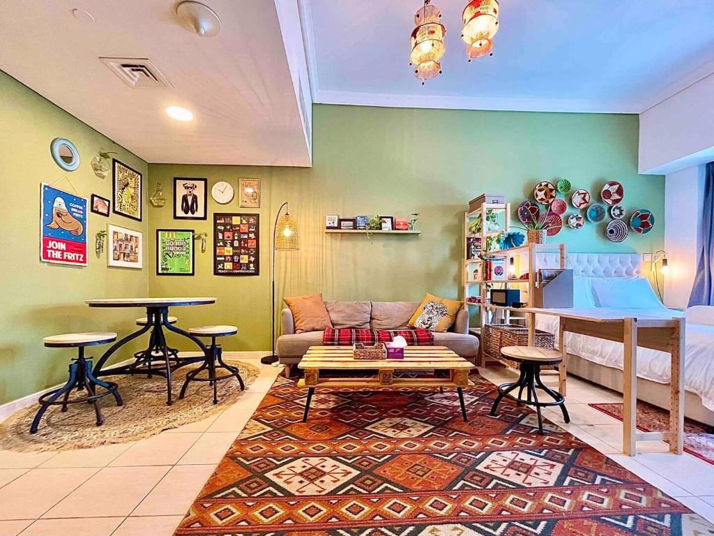 ein Wohnzimmer mit einer Couch und einem Tisch in der Unterkunft Rustic Elegance By The Lake Studio Cabin In Jlt in Dubai