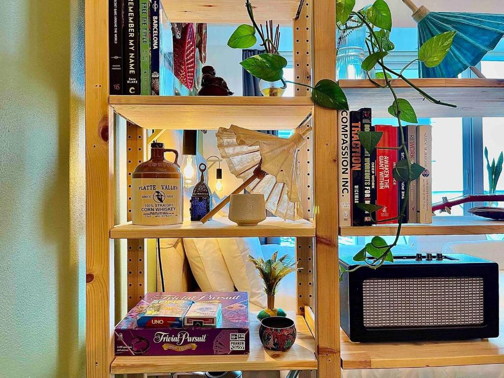 a book shelf with a microwave and books at Rustic Elegance By The Lake Studio Cabin In Jlt in Dubai