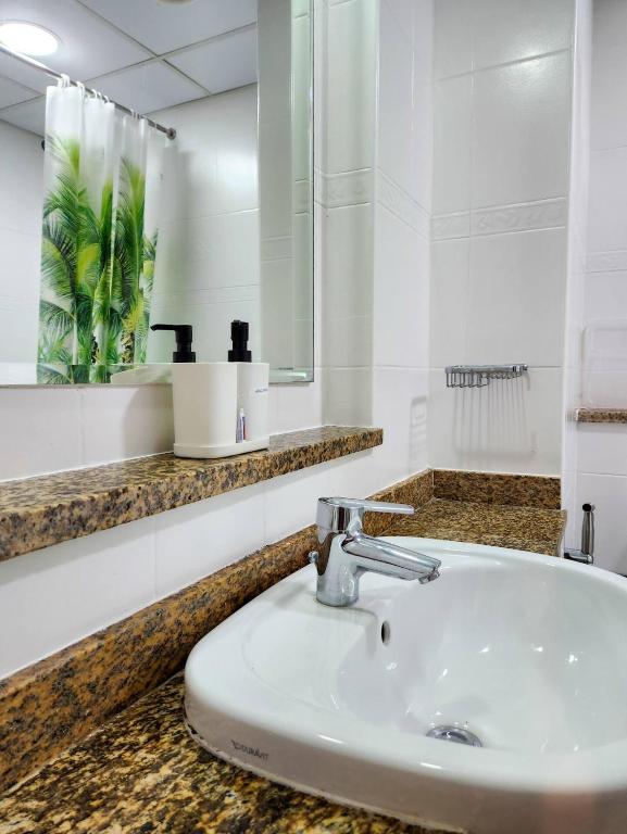 a bathroom with a sink and a mirror at Rustic Elegance By The Lake Studio Cabin In Jlt in Dubai