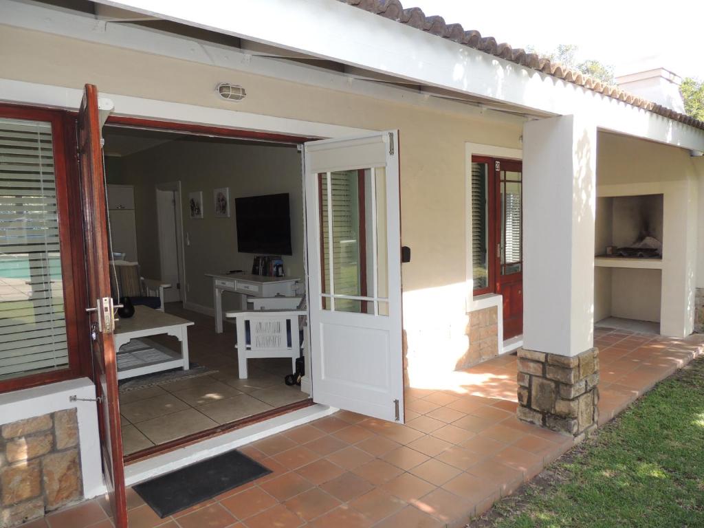 an open door to a patio with a television at The Dunes Studio 20 in Plettenberg Bay