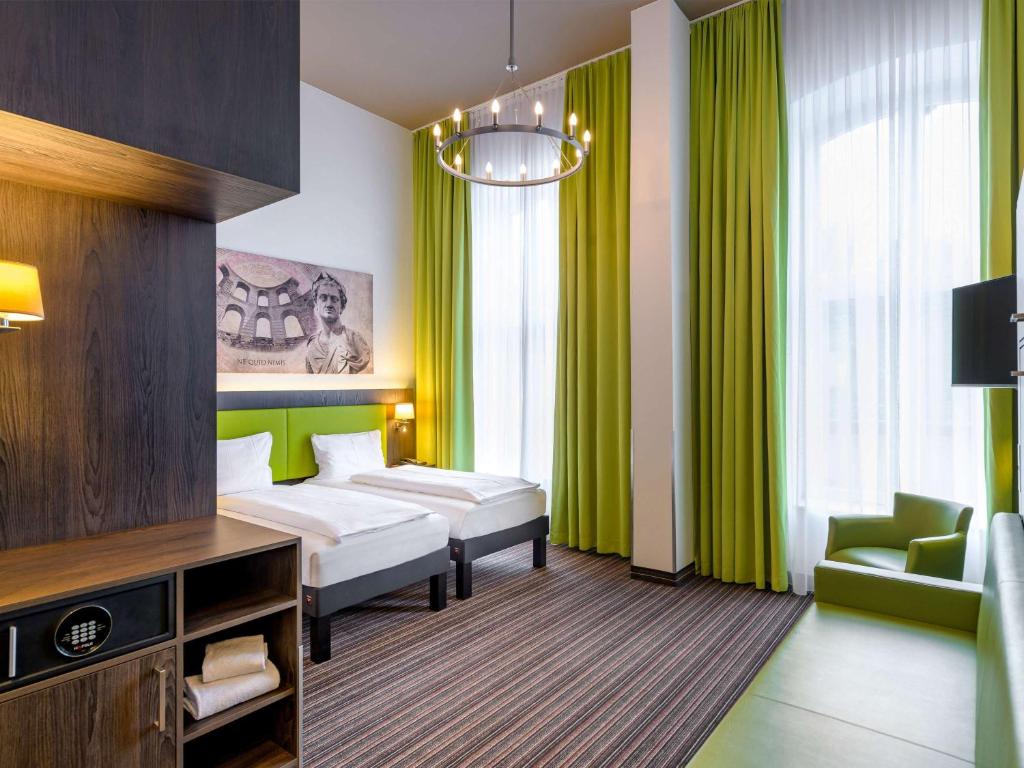 Postel nebo postele na pokoji v ubytování Ibis Styles Trier