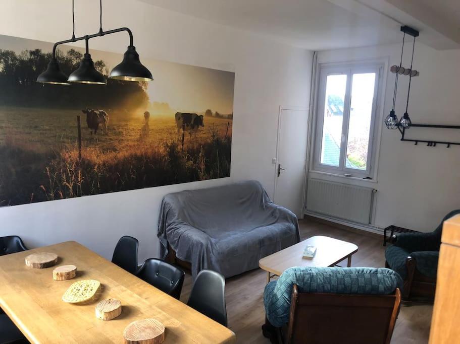 a room with a table and chairs and a window at Appartement en centre ville pour 4 personnes in Roye