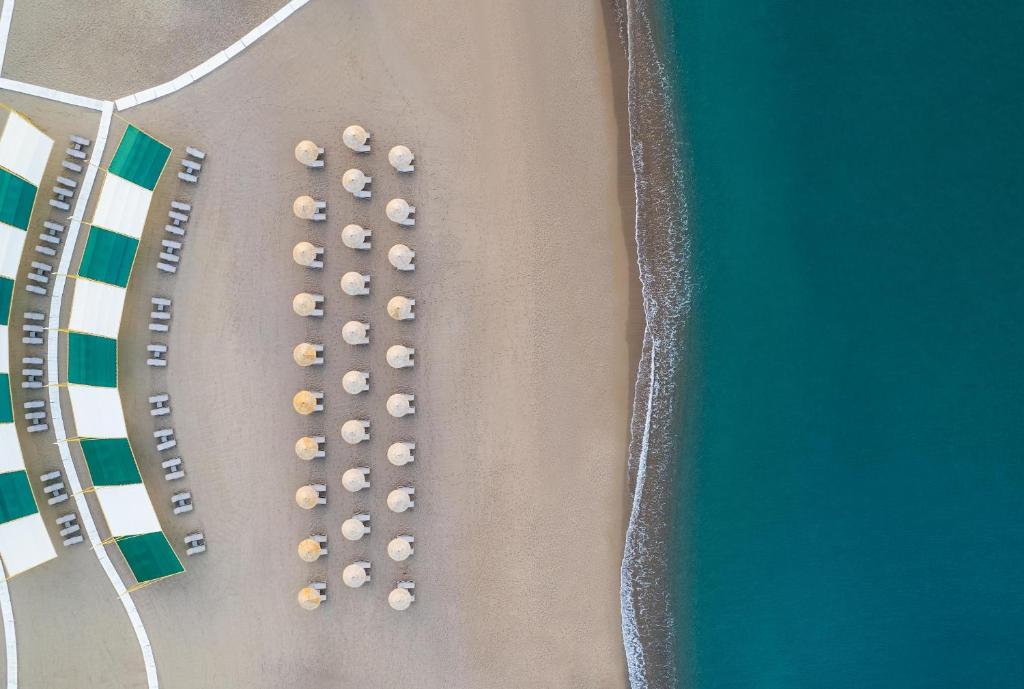 an overhead view of a beach with a bunch of umbrellas at Concorde De Luxe Resort - Prive Ultra All Inclusive in Lara
