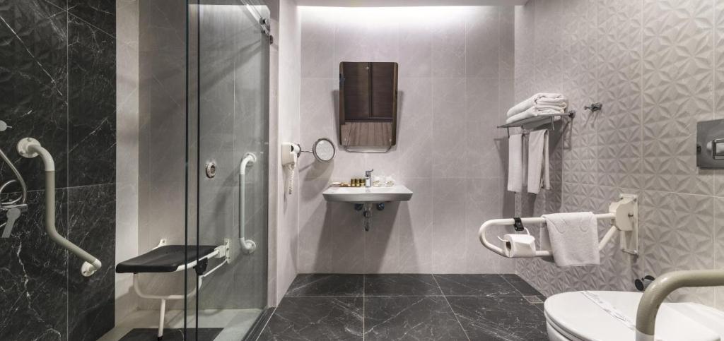 a bathroom with a shower toilet and a sink at Concorde De Luxe Resort - Prive Ultra All Inclusive in Lara
