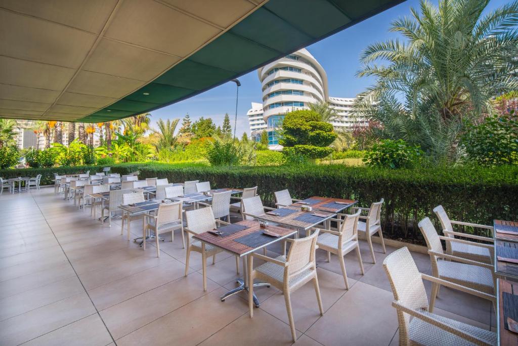 a row of tables and chairs on a patio at Concorde De Luxe Resort - Prive Ultra All Inclusive in Lara