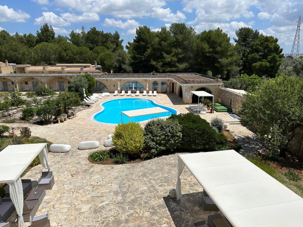 a resort with a swimming pool in a yard at Masseria Relais Santa Teresa in Sannicola