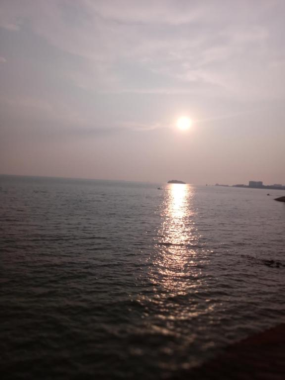 a sunset over the water with the sun in the sky at PD Corus myHoliday Homes & Apartments in Port Dickson