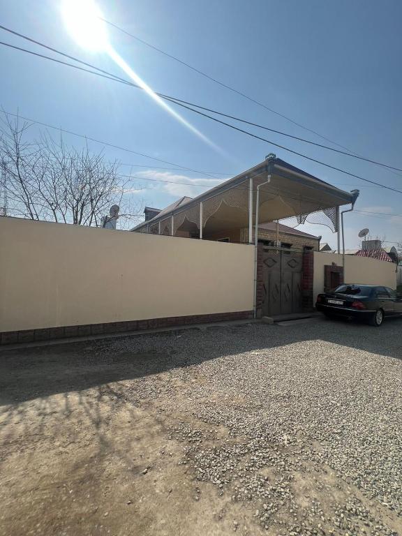 a garage with a car parked next to a building at Sah Guest Houses in Ganja