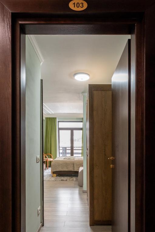 a hallway with a door open to a bedroom at CASA PRAHOVA in Predeal