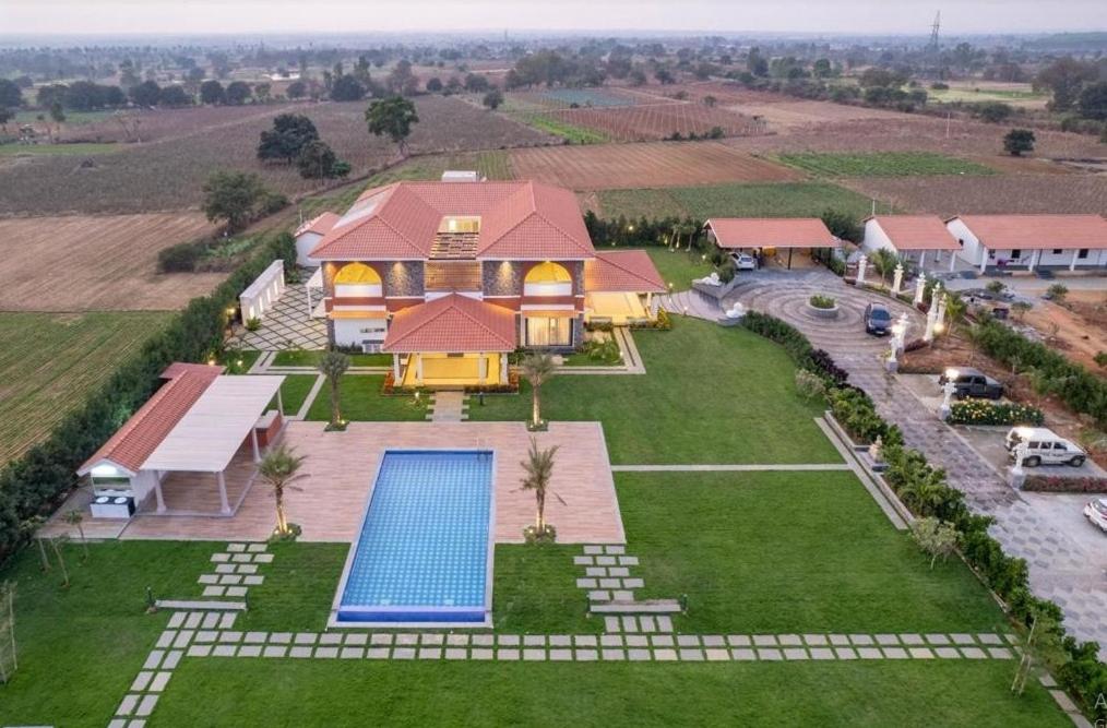 an aerial view of a house with a swimming pool at Redhomex Cove Castle Villa in Hyderabad