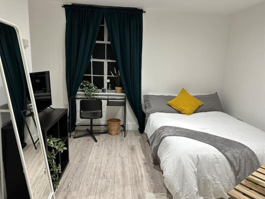 a bedroom with a bed and a desk and a window at Entire Rental Unit in Kent in Kent