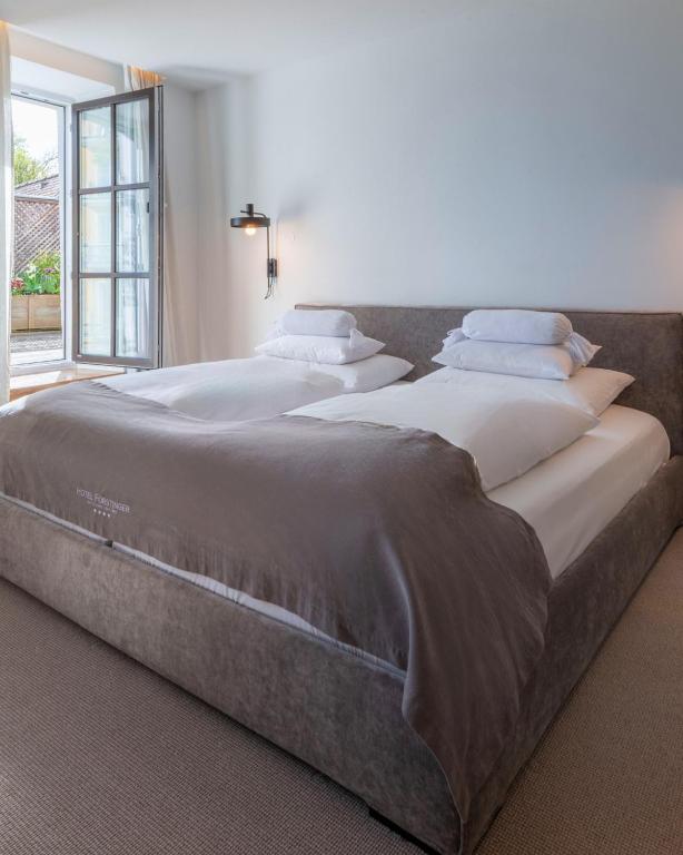 Postel nebo postele na pokoji v ubytování Hotel Forstinger - Boutique Hotel Schärding