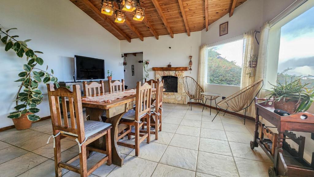 a dining room with a table and chairs and a fireplace at La gringa 1 in San Carlos de Bariloche