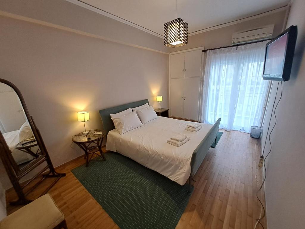 sypialnia z łóżkiem i telewizorem z płaskim ekranem w obiekcie Patras Stay w mieście Patras