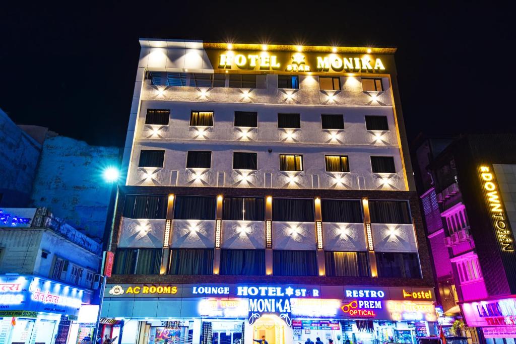 a building with a hotel on top of it at night at Hotel Star Monika in Udaipur