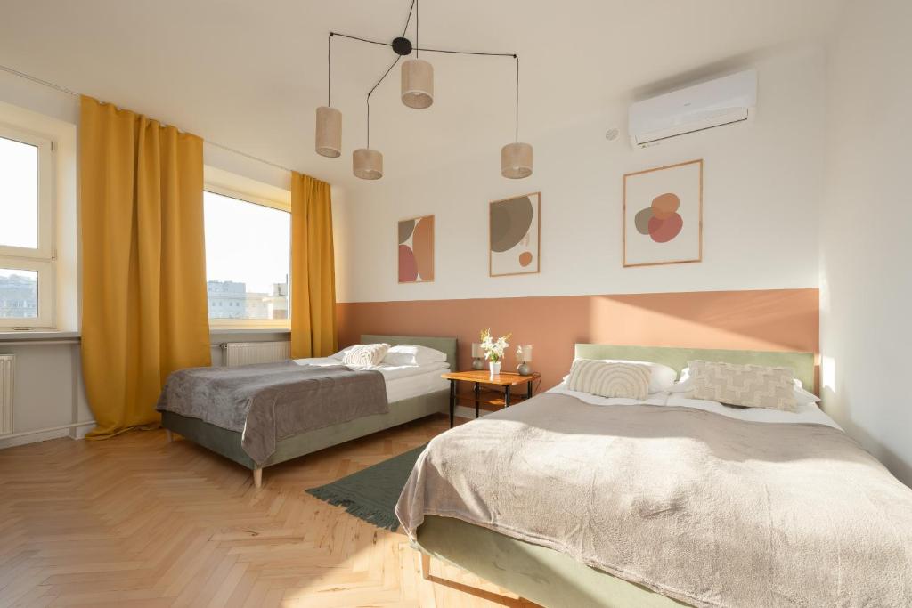 a bedroom with two beds and a window at Apartment for 6 people near Royal Baths Park by Renters Prestige in Warsaw