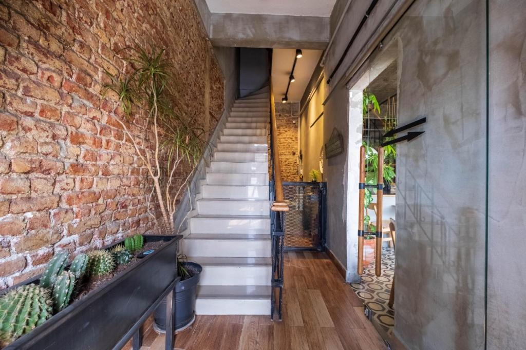 a brick wall and stairs in a hallway with cactus at Elite Marmara Express Otel in Istanbul