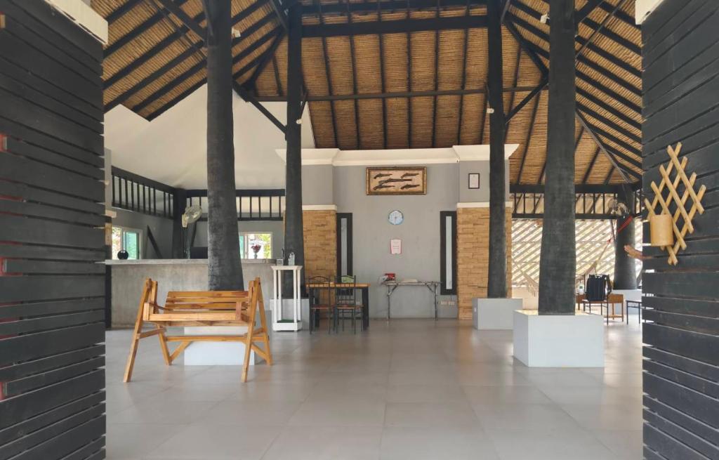 a room with a wooden bench in the middle of it at Siri Maya Garden Home Samui in Koh Samui 
