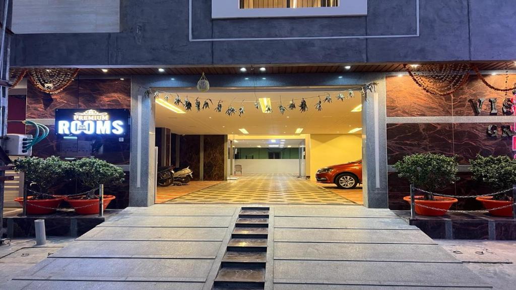 a front door of a building with a car in it at Vishnu Grand Premium Rooms Rajahmundry in Rājahmundry
