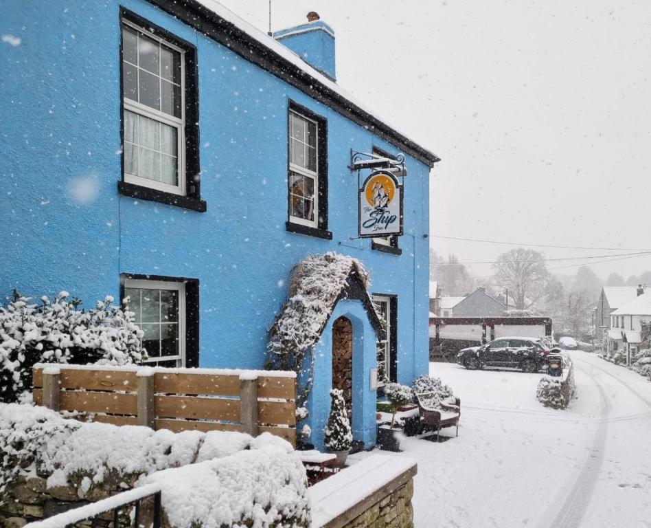 a blue building with snow on top of it at The Ship Inn in Bardsea