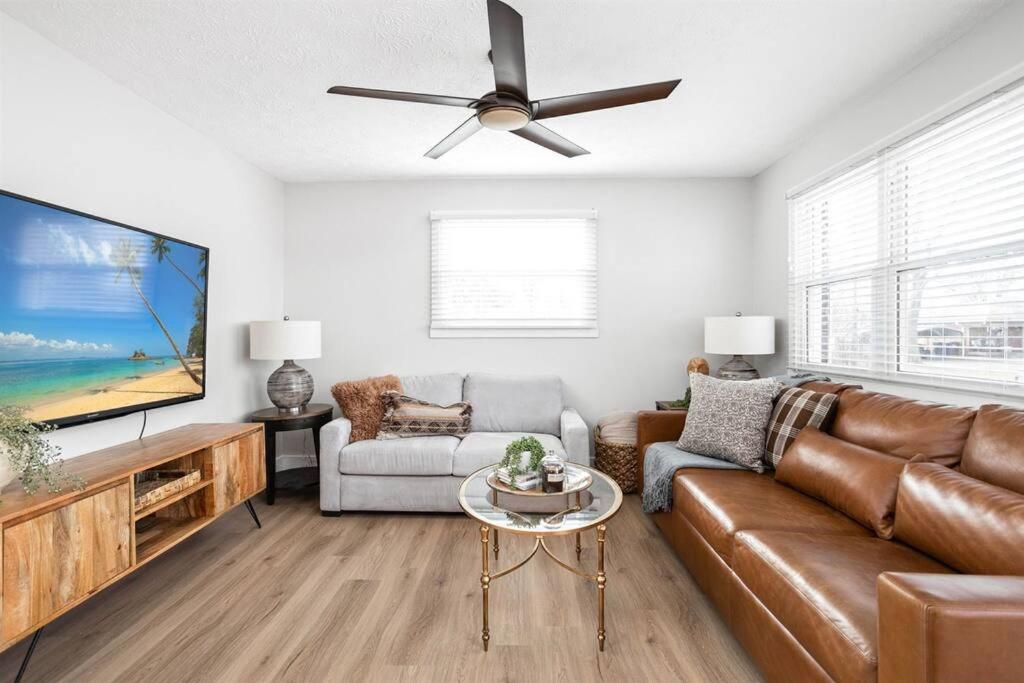 a living room with a couch and a flat screen tv at Newly Renovated Retreat 30mins to Downtown Indy in Brownsburg