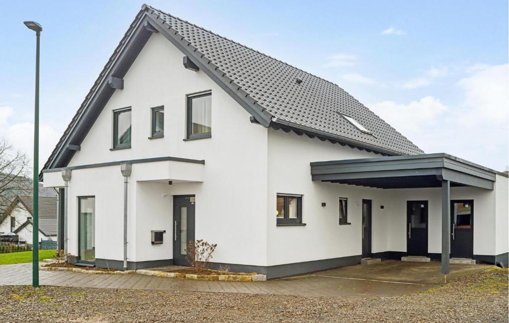 a white house with a black roof at Gorgeous Apartment In Attendorn in Attendorn