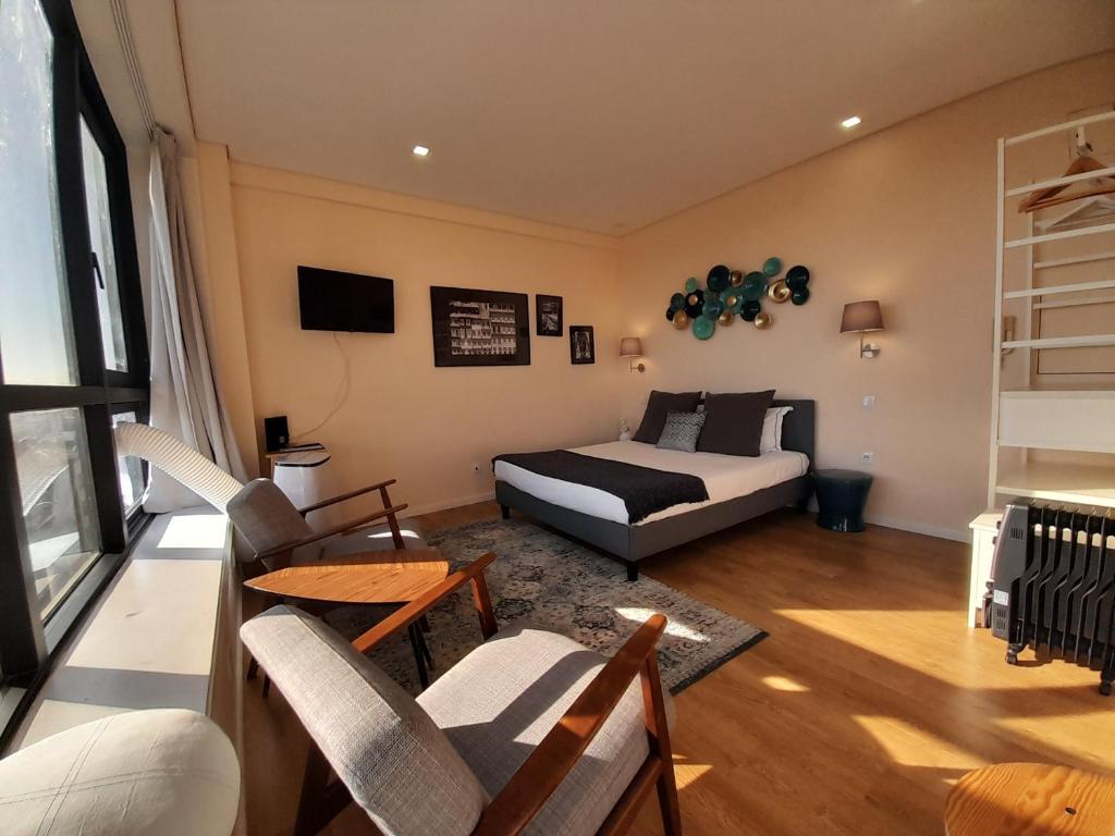 een woonkamer met een bed en een bank bij Vista Bolhão Studio in Porto