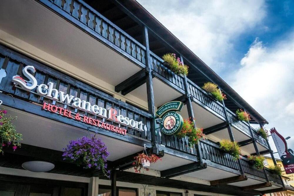 a building with a balcony with plants on it at Schwanen-Resort in Baiersbronn