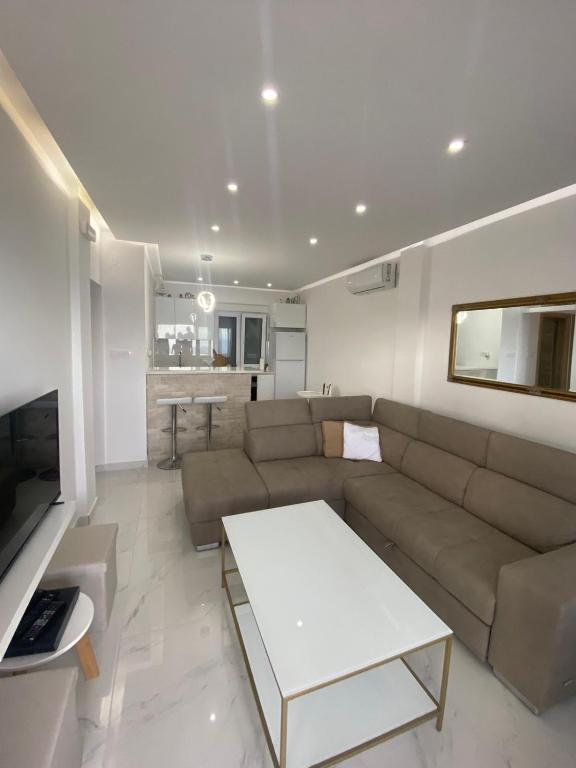 a living room with a couch and a table at Vini Apartments in Zagrađe